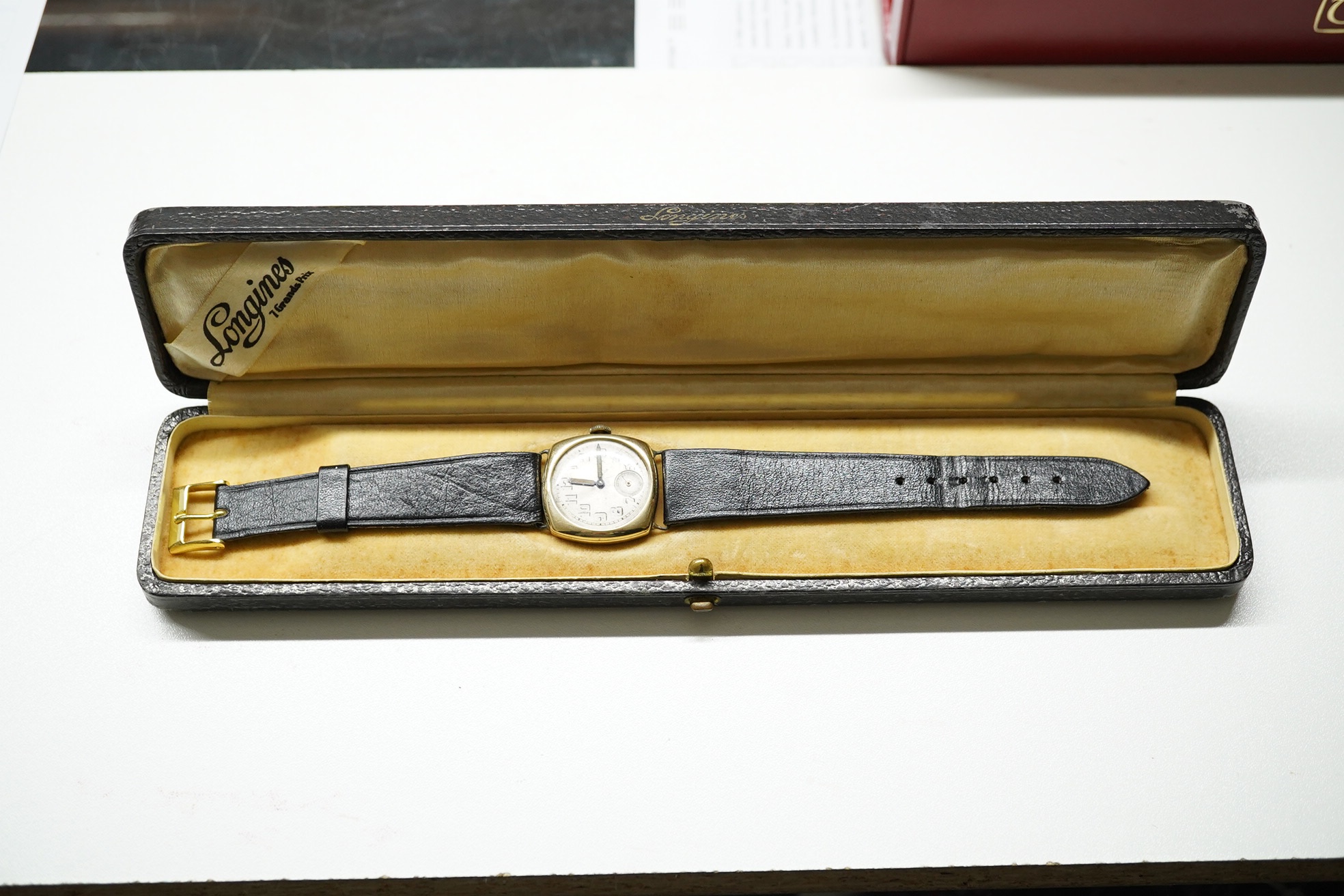 A gentleman's 1920's 14k Longines manual wind wrist watch, with Arabic dial and subsidiary seconds, case diameter 27mm, on associated leather strap, with associated Longines box. Condition - poor